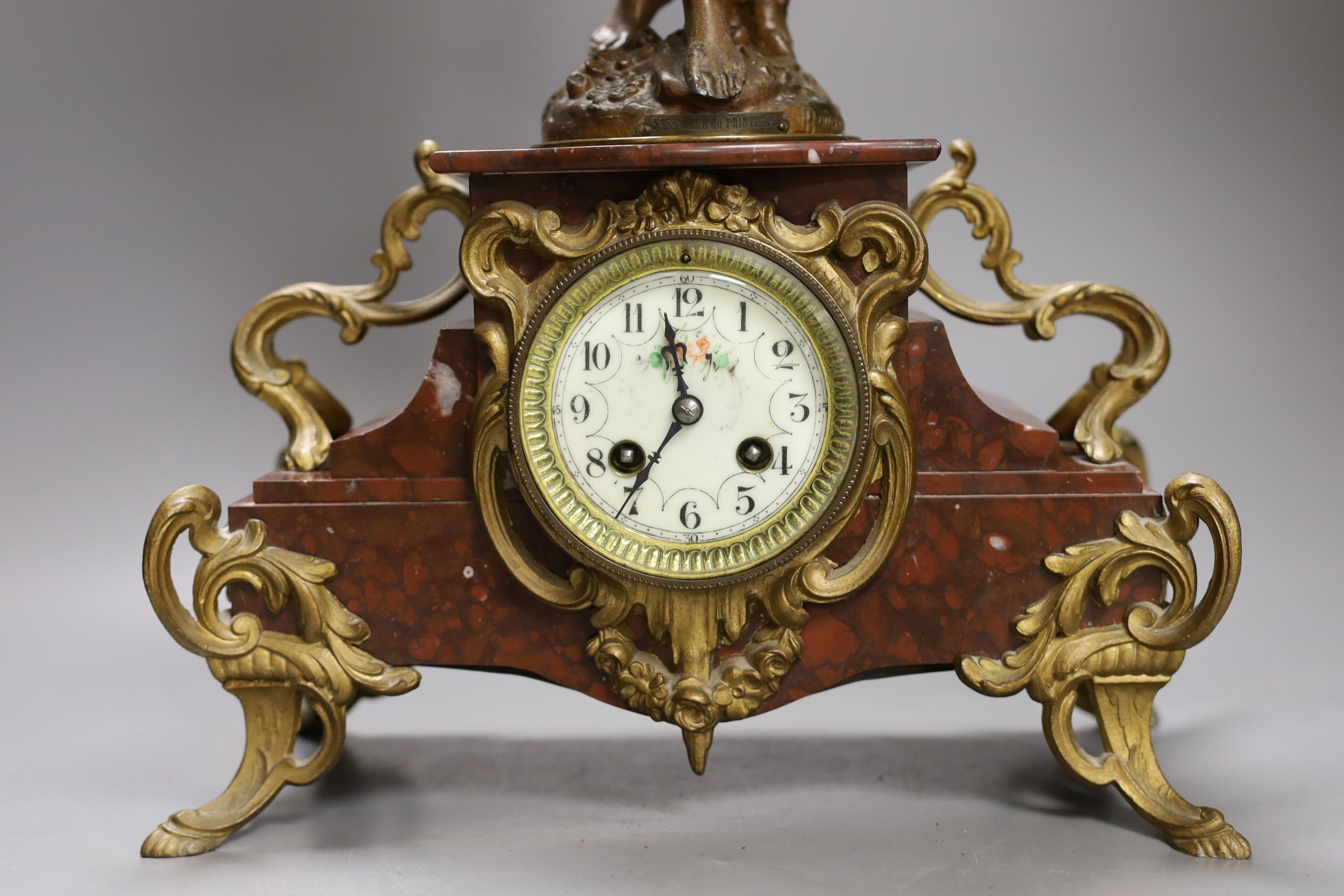 A bronzed spelter and rouge marble figural mantel clock 65cm